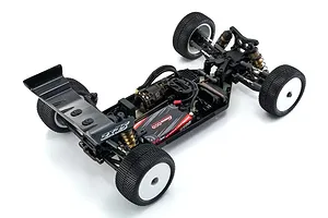 High-angle view of a Kyosho Lazer ZX7.5 1/10 scale 4WD electric RC buggy chassis, fully assembled with motor, battery, and white wheels.