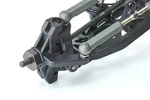 Close-up of the front suspension assembly of a 1/10 scale RC buggy, showing the steering knuckle, wheel hex, and suspension arms.
