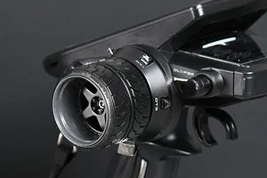 Close-up of a Pandora RC custom steering wheel installed on a Futaba RC transmitter, featuring a realistic tire tread design.