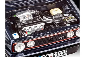 Close-up of a detailed 1/24 scale model car engine bay for a 1983 VW Golf GTI, showing the engine, Varta battery, and front grille.