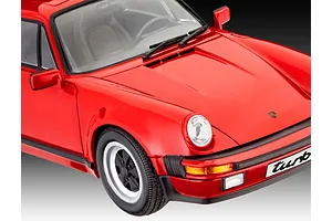 A close-up view of a red 1/24 scale model of a 1975 Porsche 911 Turbo, showing the front hood, windshield, and front bumper details.