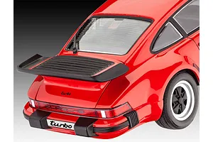 Rear three-quarter view of a red Revell 1/24 scale 1975 Porsche 911 Turbo plastic model car kit showing the rear spoiler and taillights.