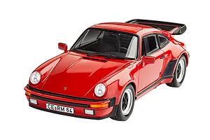 A high-angle studio shot of a red 1975 Porsche 911 Turbo plastic model car with a black rear spoiler and license plate reading CE RM 64.