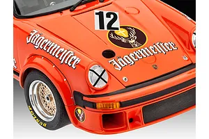 Close-up of a 1/24 scale Porsche 934 RSR Jägermeister model car showing the front hood, headlight, and wheel with racing decals.