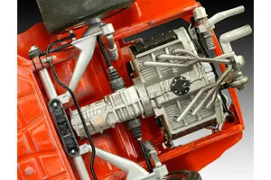 Close-up view of the underside of a 1/24 scale Porsche 934 RSR model car, showing the detailed engine, transmission, and suspension components.