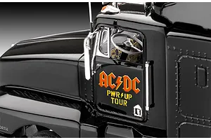 Close-up of the driver side door of a black Revell AC/DC Power Up Tour model truck, showing the logo and interior dashboard.