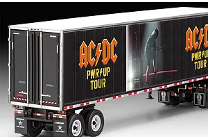 A close-up view of the rear and side of a Revell 1/32 scale AC/DC Power Up Tour model truck trailer with black livery and band graphics.