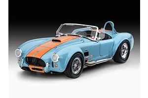 A completed 1/24 scale model of a light blue Shelby Cobra 427 with orange racing stripes, chrome wheels, and side-exit exhaust pipes.