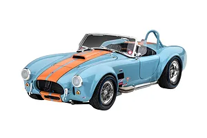 A 1/24 scale model of a light blue Shelby Cobra 427 with orange racing stripes, featuring chrome wheels and side-exit exhaust pipes.