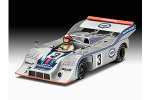 A studio shot of a completed Revell 1/32 scale Porsche 917/10 Martini racing model car with a driver figure, featuring silver paint and Martini racing decals.