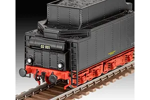 A close-up view of the rear tender section of a black and red Revell BR02 steam locomotive model sitting on brown plastic train tracks.