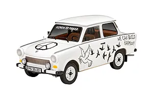 A 1/24 scale model of a white Trabant 601S car with peace-themed decals including a peace sign, doves, and the text 'DRIVIN TO PEACE' and 'WE CAN BUILD HARMONY'.