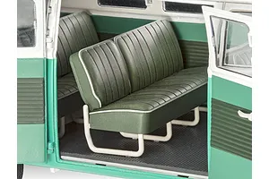 Interior view of a 1/24 scale Revell VW T1 Bus model showing green bench seats with white piping and white metal-look frames.