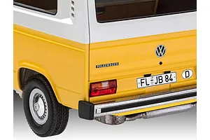 Close-up of the rear corner of a yellow and white Revell 1/24 scale VW T3 model bus showing the taillight, bumper, and license plate.