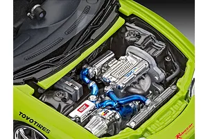Close-up of the detailed engine bay of a lime green 1/25 scale model Mitsubishi Eclipse, featuring chrome engine parts and blue intake piping.