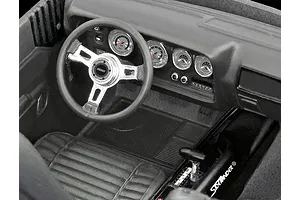 A detailed interior view of a 1/24 scale model car, showing a dashboard, steering wheel with Grant logo, and center console with Sidewinder shifter.