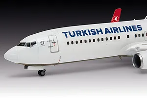 A close-up side view of a 1/144 scale plastic model of a Turkish Airlines Boeing 737-800, showing the cockpit, fuselage, and engine.