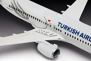 A close-up view of a 1/144 scale Revell Boeing 737-800 model aircraft in Turkish Airlines livery, showing the fuselage, wing, and engine detail.