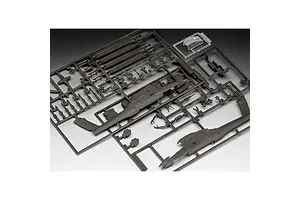 Plastic model kit sprues for a 1/100 scale AH-64A Apache helicopter, showing grey fuselage parts, rotor blades, and a clear canopy piece.