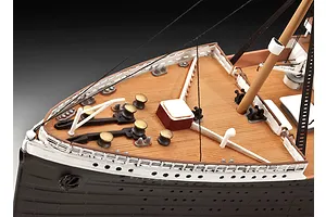 Close-up of the bow deck of a painted Revell Titanic model kit showing wooden-textured decking, railings, and deck equipment.