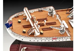 High-angle view of the stern deck of a Revell 1/400 scale RMS Titanic model, showing the wooden-textured deck, white railings, cranes, and a British flag.