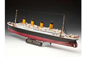 A fully assembled 1/400 scale plastic model of the RMS Titanic, featuring four yellow funnels, black and white hull, and a display stand with a nameplate.