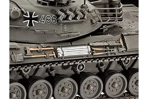 Close-up of a 1/35 scale Leopard 1 tank model showing the side hull, turret, road wheels, and attached tools.