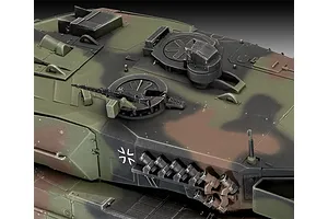 Close-up of the turret top of a painted 1/35 scale Leopard 2 A6 model tank showing camouflage paint, hatches, and a mounted machine gun.