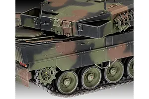 Close-up of a 1/35 scale plastic model of a Leopard 2 tank showing the rear hull, tracks, and turret side with camouflage paint.