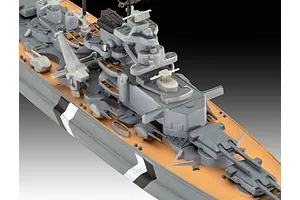 Close-up of a 1/1200 scale plastic model of the Bismarck battleship, showing the superstructure, deck, and turret details.