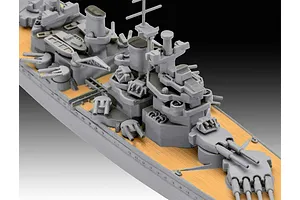 Close-up of a 1/1200 scale plastic model battleship deck showing grey turrets and tan decking.