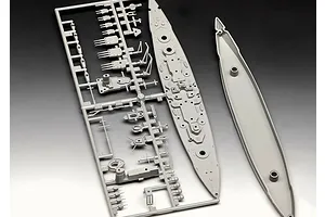 Grey plastic model kit sprue containing parts for a 1/1200 scale Gneisenau battleship model, including the deck and hull sections.