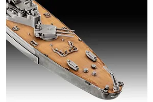Close-up of the deck of a 1/1200 scale Revell USS New Jersey battleship model kit, showing grey turrets and a wood-textured deck.