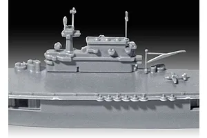 Close-up of the grey plastic island structure and flight deck of a 1/1200 scale USS Enterprise CV-6 model kit.