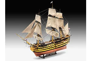 A fully assembled and painted 1/225 scale plastic model of the HMS Victory ship, featuring detailed sails, rigging, and a display stand.
