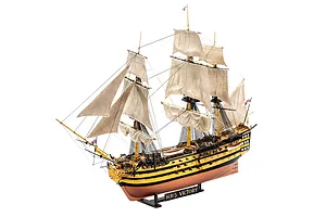 A fully assembled and painted 1/225 scale plastic model of the HMS Victory ship, featuring detailed sails, rigging, and a black display stand.