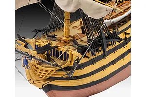 Close-up of the deck and bow section of a finished Revell HMS Victory plastic model ship, showing detailed rigging, cannons, and painted hull.
