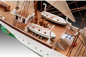 Close-up of the deck of a Gorch Fock ship model, showing lifeboats, rigging, and wooden-textured decking.