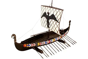 A fully assembled 1/50 scale Revell Viking ship plastic model kit featuring a square sail with a black bird emblem and colorful shields along the hull.