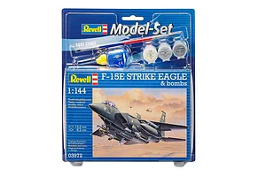 Revell 1/144 scale F-15E Strike Eagle model kit in blister packaging, including paint pots, glue, and a paintbrush.