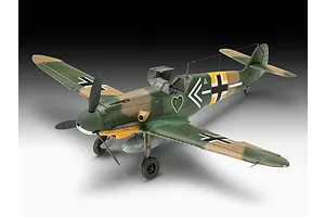 A completed 1/32 scale plastic model of a Messerschmitt Bf 109 fighter aircraft with green and tan camouflage and a heart emblem on the side.