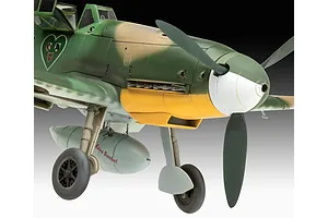 Close-up of a 1/32 scale Messerschmitt Bf 109 model aircraft showing the nose, propeller, and landing gear with a drop tank labeled 'Keine Bombe!'.