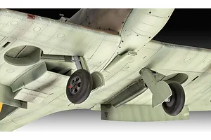 Underside view of a 1/32 scale plastic model Spitfire aircraft showing landing gear, wheels, and panel lines.