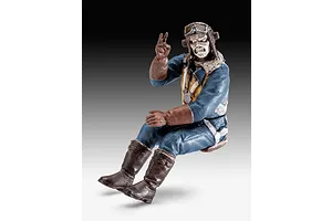 A painted 1/32 scale pilot figure of Eddie from Iron Maiden, wearing a flight suit, goggles, and gloves, posed in a seated position.