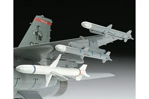 Close-up of a plastic model F-16 fighter jet wing showing mounted missiles and tail section details.