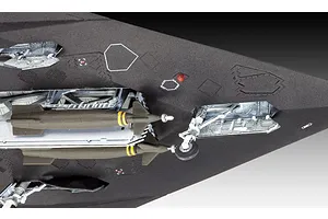 Close-up of the underside of a plastic model F-117 Nighthawk showing open bomb bay doors with two missiles and landing gear.