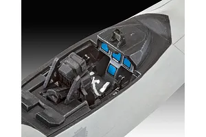 Close-up of the assembled and painted cockpit interior of a 1/72 scale F-22A Raptor model kit, showing the seat, instrument panel, and control stick.