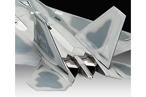 Close-up view of the rear section of a painted F-22A Raptor model aircraft, showing the tail fins, exhaust nozzles, and camouflage paint scheme.