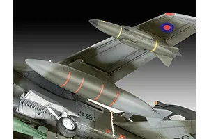 Close-up of a 1/72 scale Panavia Tornado plastic model aircraft showing the underside, landing gear, and external fuel tanks against a gradient background.