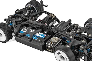 Close-up of the chassis of a Team Associated 1/28 scale RC car, showing the motor, battery, servo, and drivetrain components.
